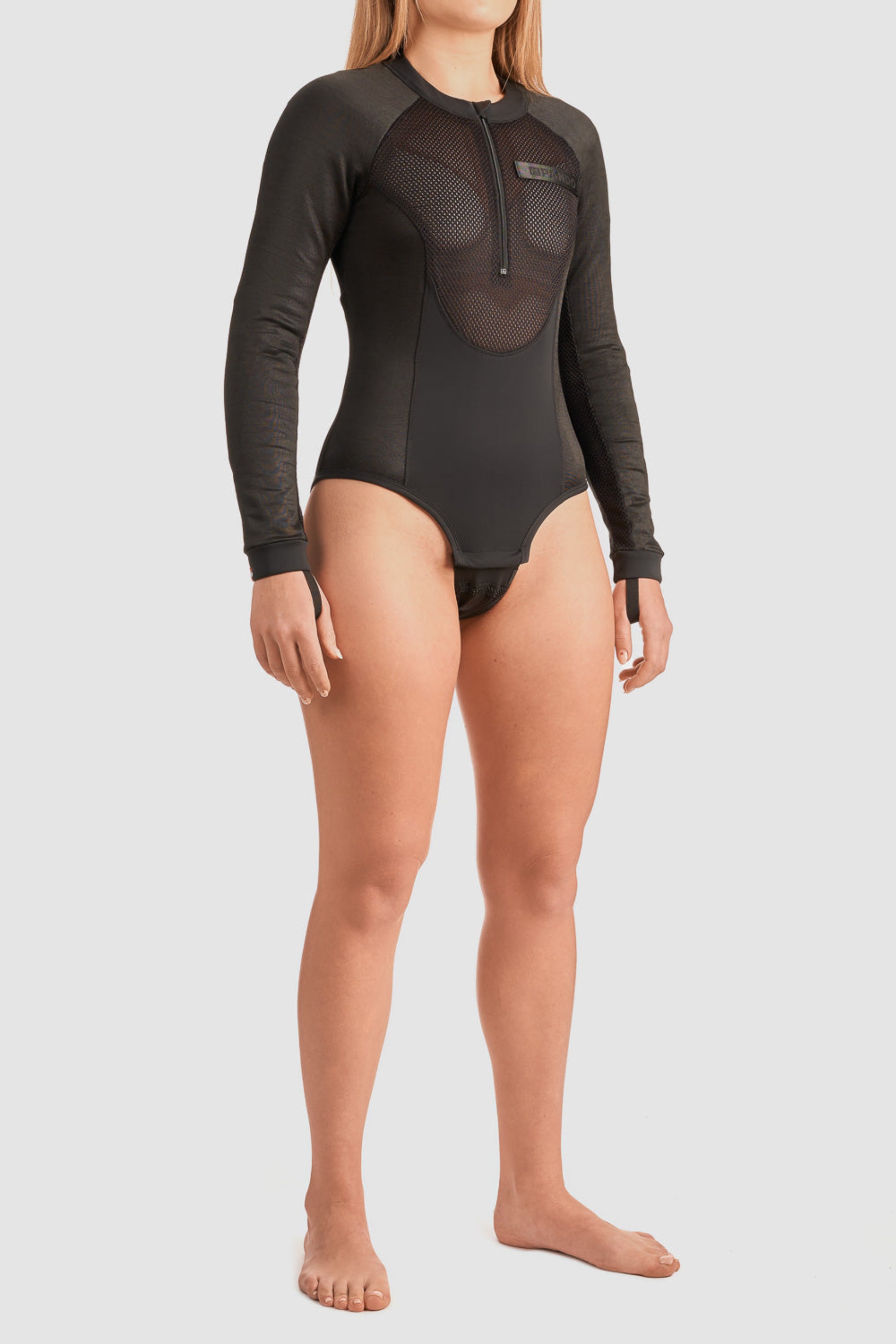 a woman wearing black body suit base layer for women from Pando