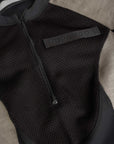 pando logo on a Black and grey moto bodysuit