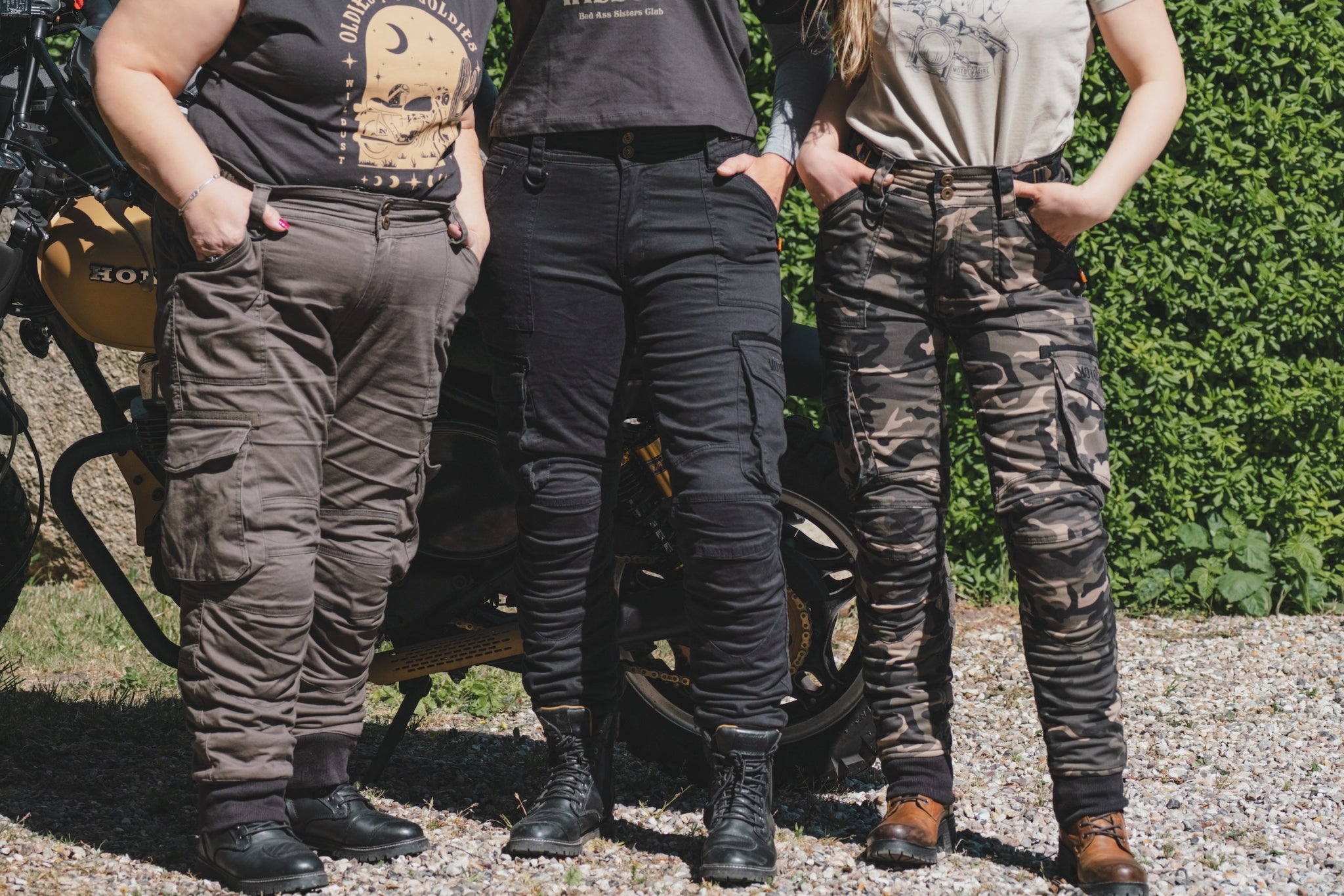 three women of difference sizes demonstrating the motorcycle cargo pants in different colous