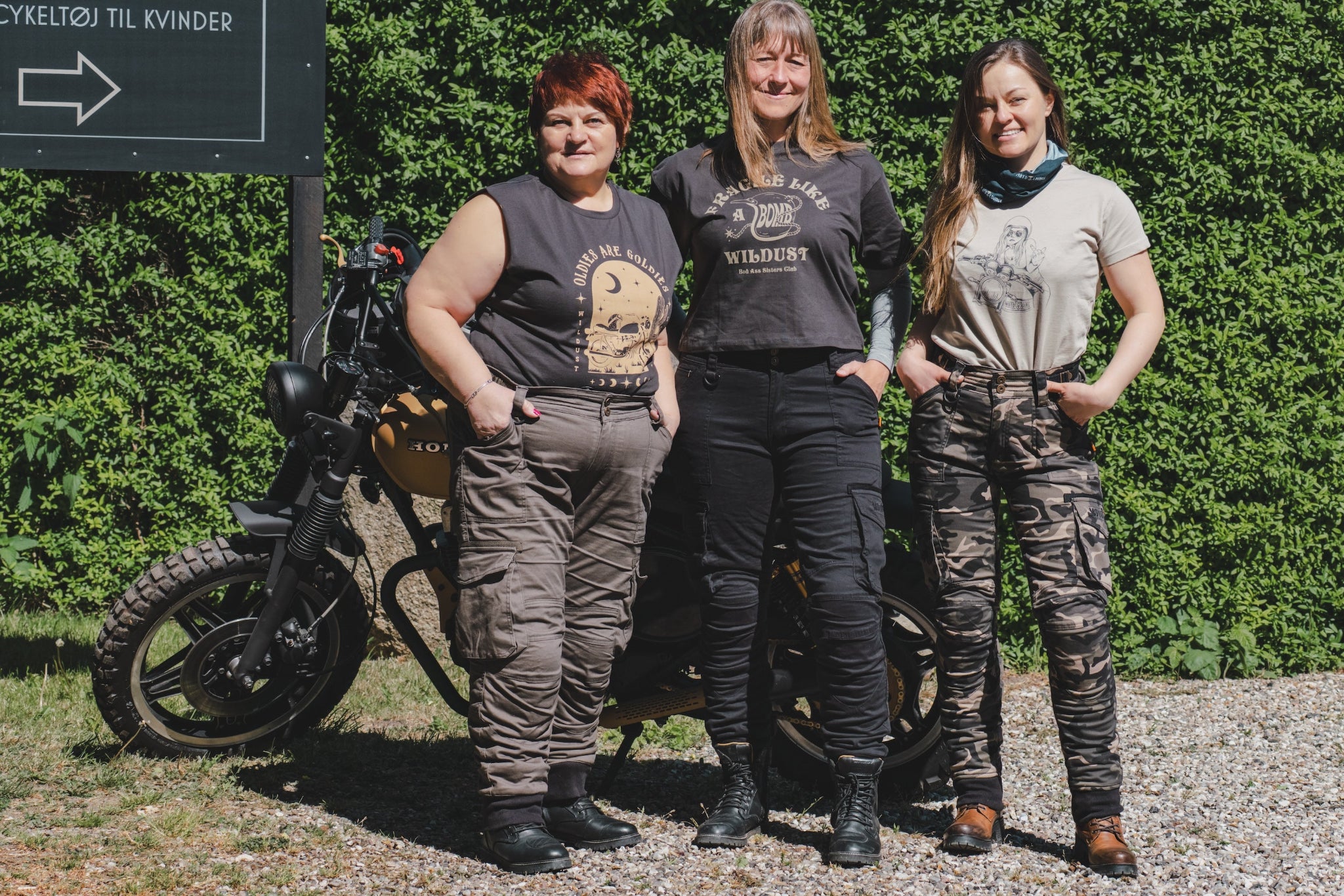 three women of difference sizes demonstrating the motorcycle cargo pants in different colous
