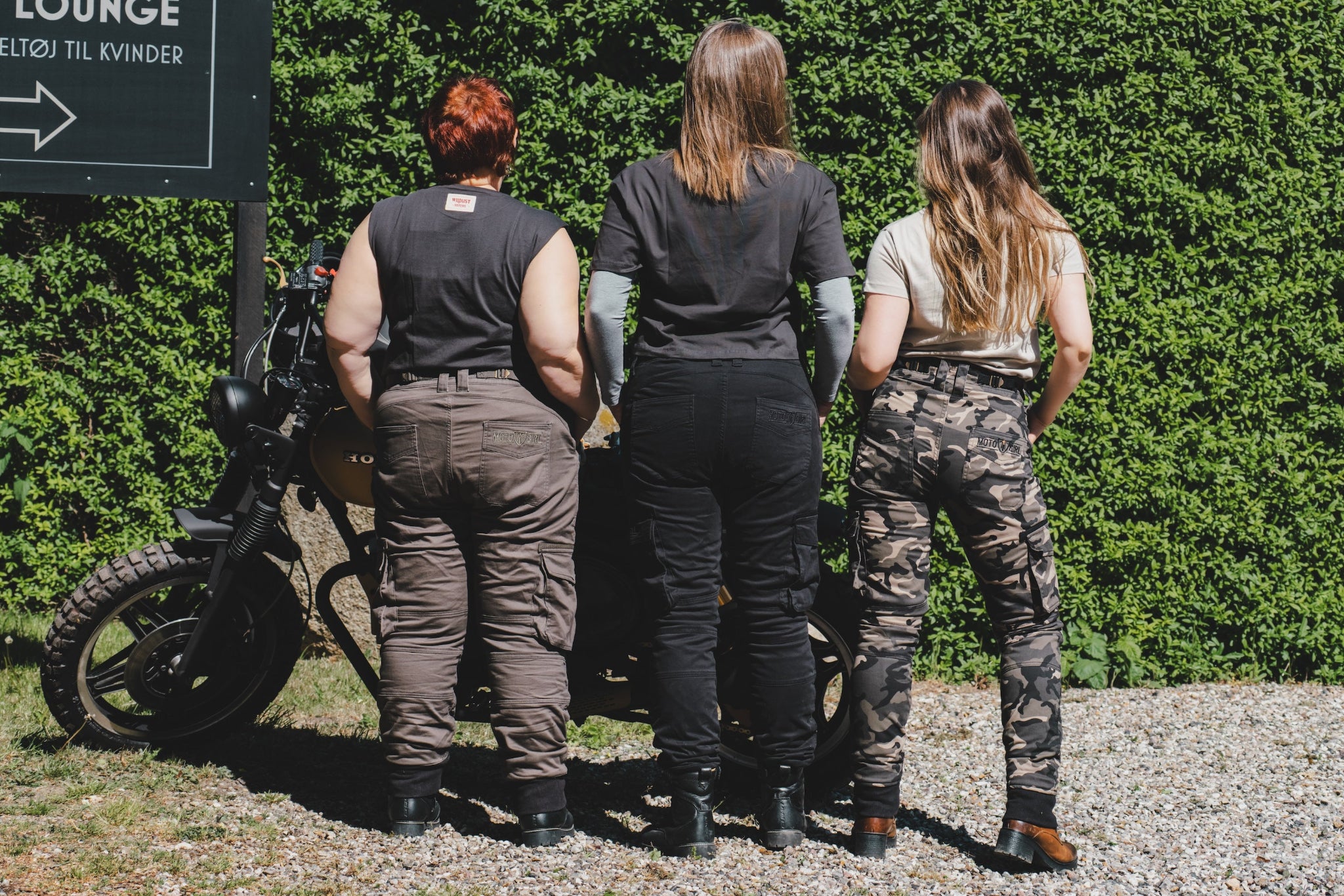 three women of difference sizes demonstrating the motorcycle cargo pants in different colous