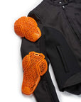 Black jacket with orange protective gear on a white background