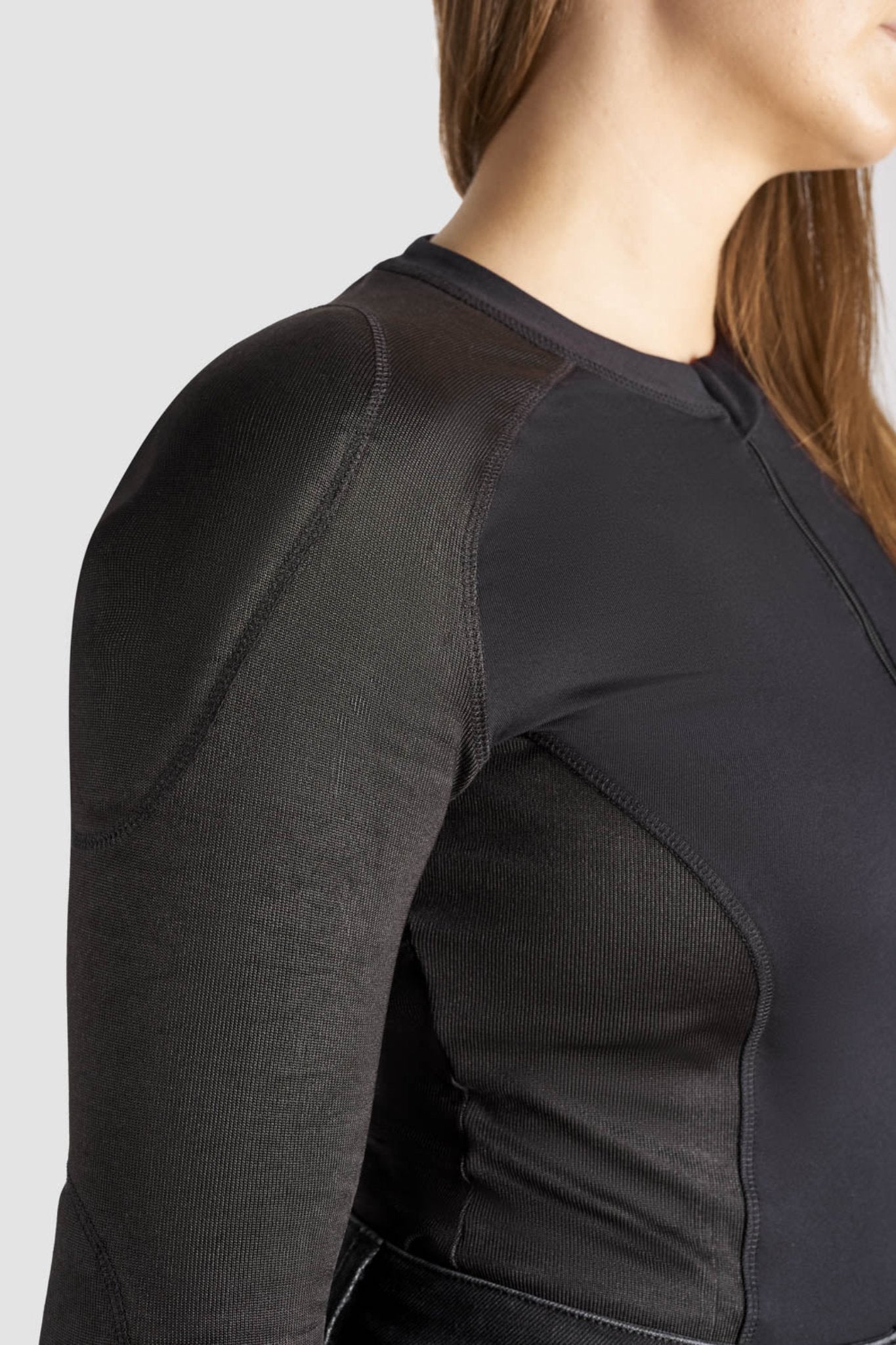 a close up of woman's shoulder wearing black motorcycle body suit from Pando Moto