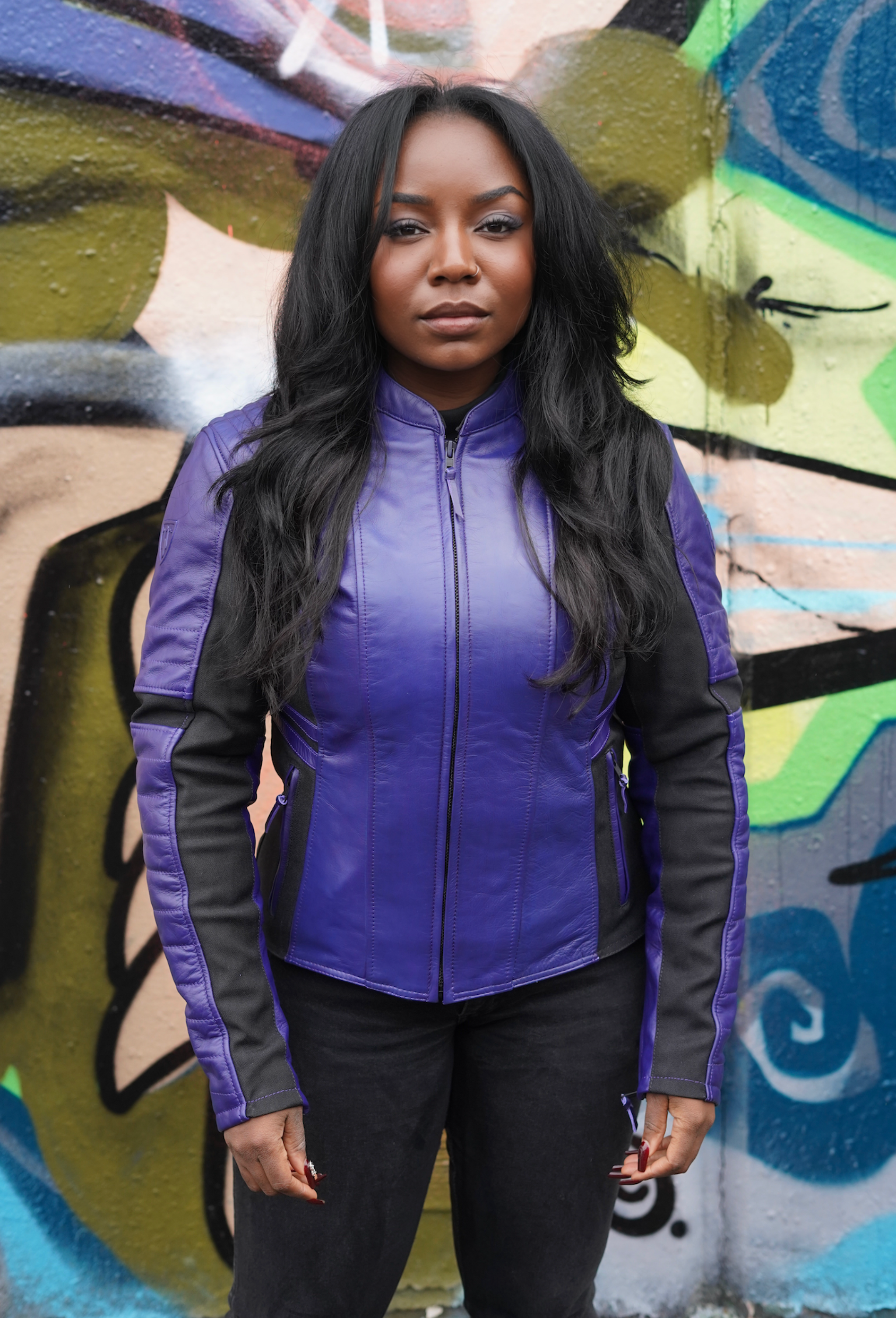 a black woman wearing purple motorcycle leather jacket for women with front zipper