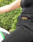 women's siting on a motorcycle waist wearing black mc jeans with high waist