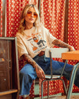 a woman wearing off white/creame colour t-shirt with retro motive that says No bullshit