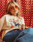 a woman wearing off white/creame colour t-shirt with retro motive that says No bullshit