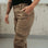 Woman's leg wearing beige motorcycle cargo pants from Moto Girl