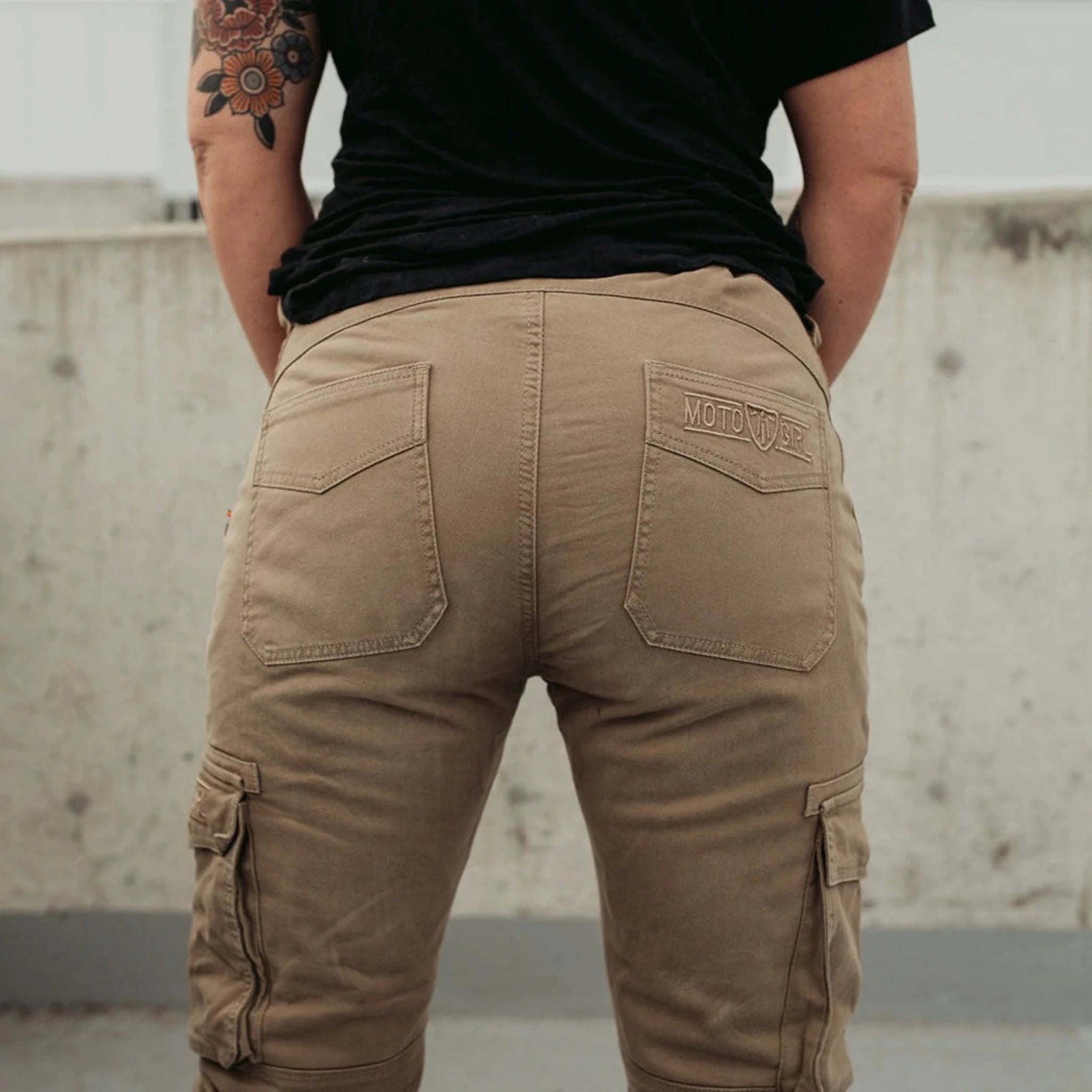 A woman's bottom wearing beige women's motorcycle cargo pants from mOTO gIRL