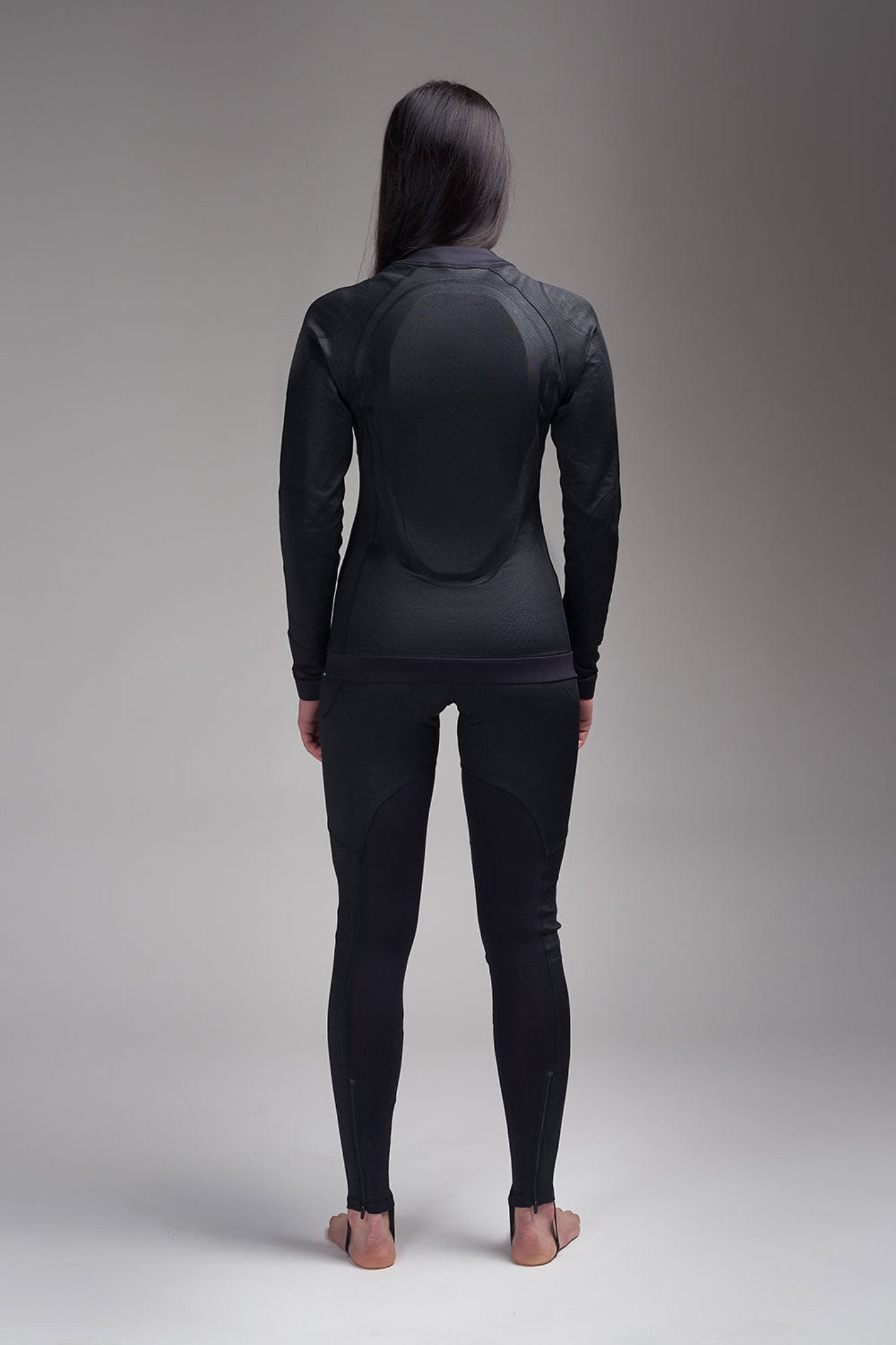 A woman posing from her back wearing protective motorcycle underwear