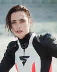 A woman wearing Women's racing suit MIURA RS in black, white and fluo from Shima