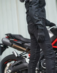 A woman standing near the motorcycle wearing Black leather and textile women motorcycle gloves from shima