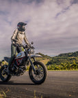 A woman on a motorcycle wearing black and green women's motorcycle leggings from exagon66