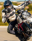 A woman on a motorcycle wearing black and green women's motorcycle leggings from exagon66