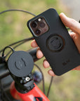 A phone and its holder mounted on a motorcycle