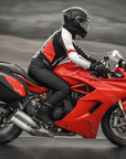 A woman on a red motorcycle wearing black women's motorcycle leggings from exagon66