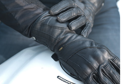 Women hands wearing Long leather black women&#39;s motorcycle glove