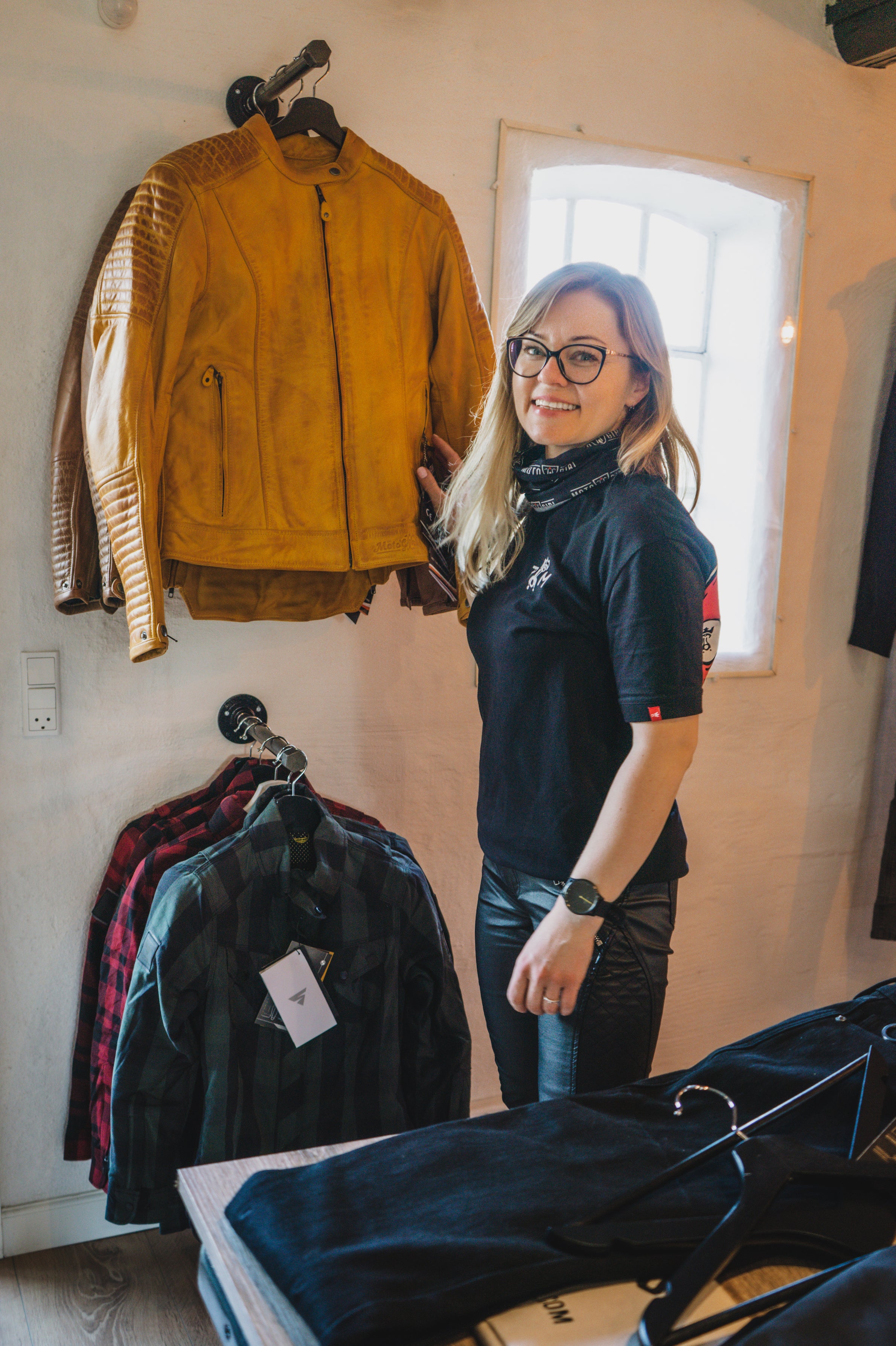 A woman in the motorcycle clothes shop