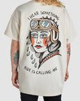 A woman wearing I hear something - ride is calling me motorcycle t-shirt