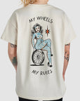 a woman wearing beige mc t-shirt with motive my wheels - my rules