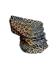 A neck gaiter or balaclava featuring a multi-pattern design with a giraffe print, zebra stripe, and leopard print, folded to show the pattern variety. A small 'MOTO GIRL' brand label is visible on the lower right edge.