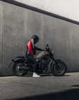 young woman motorcyclists in black red leather jacket