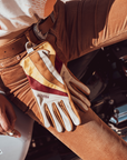colourful leather motorcycle lady gloves from Wildust hanging from the woman's belt