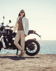 a woman by her motorcycle wearing white denim mc shirt