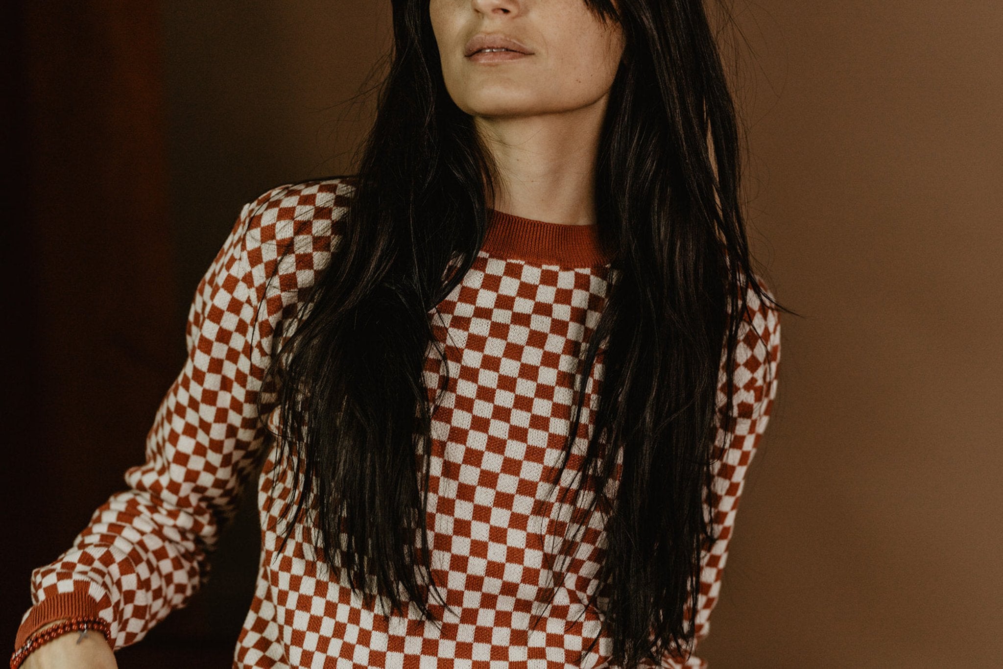 a young woman wearing a knitted red and white jumper with chessboard motives from Wildust