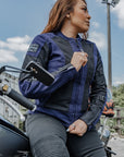 red hair woman leaning on her motorcycle wearing Blue and black women motorcycle mesh jacket from MotoGirl 