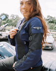 Red hair woman zipping up a Blue and black women motorcycle mesh jacket from MotoGirl 