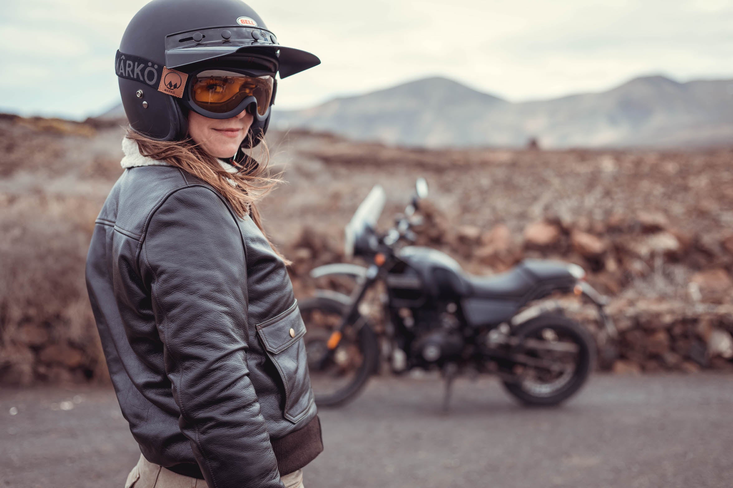 woman motorcyclists wearing brown aviator style jacket