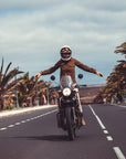 a woman on a motorcycle wearing brown khaki denim mc shirt