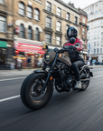 woman motorcyclists in black red leather jacket on her bike riding in London