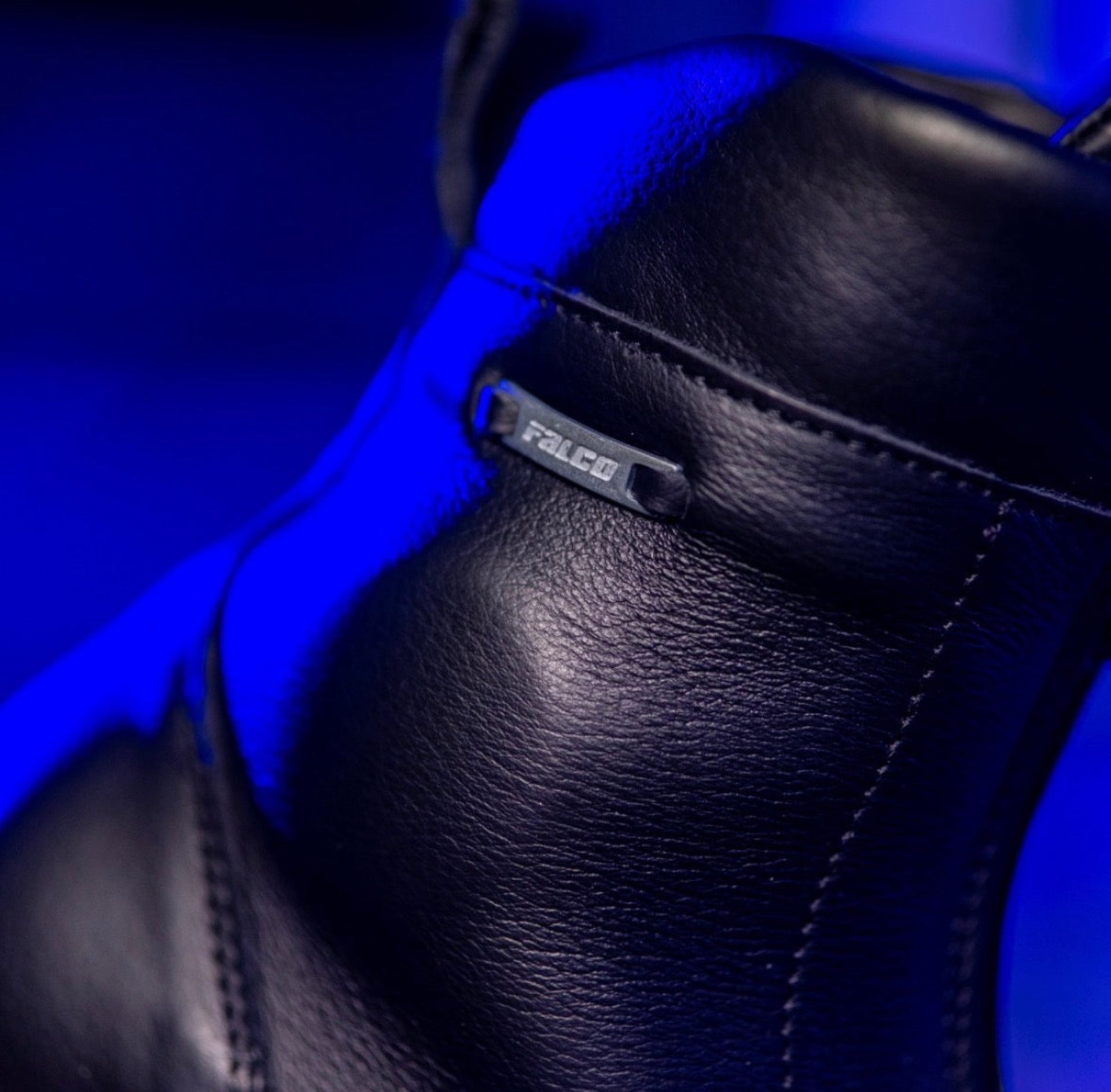 Black leather boot with 'Falco' branding on a blue background