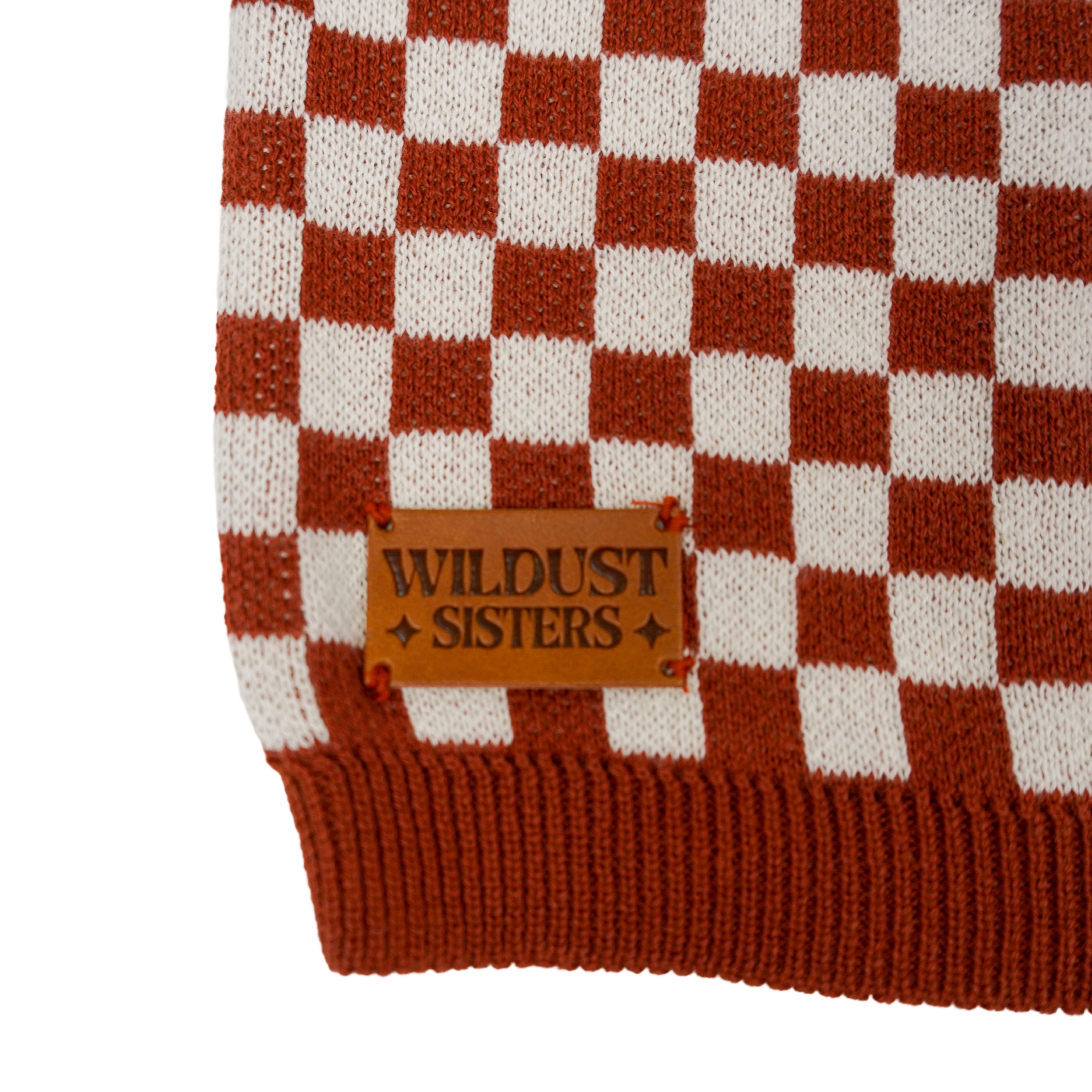 a wildust leather patch on a knitted red and white jumper with chessboard motives from Wildust
