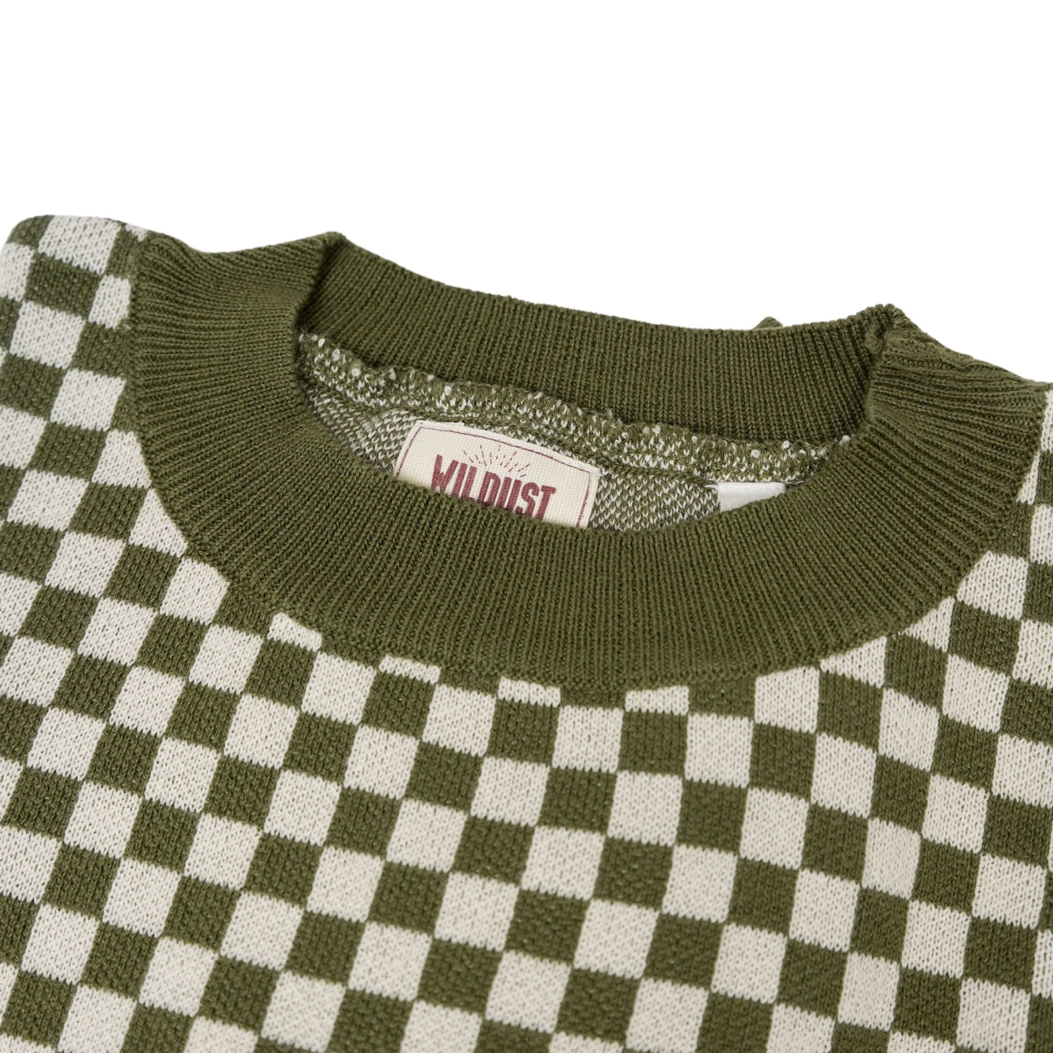 a collar of a knitted khaki green and white jumper with chessboard motives  from Wildust