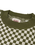 a collar of a knitted khaki green and white jumper with chessboard motives  from Wildust