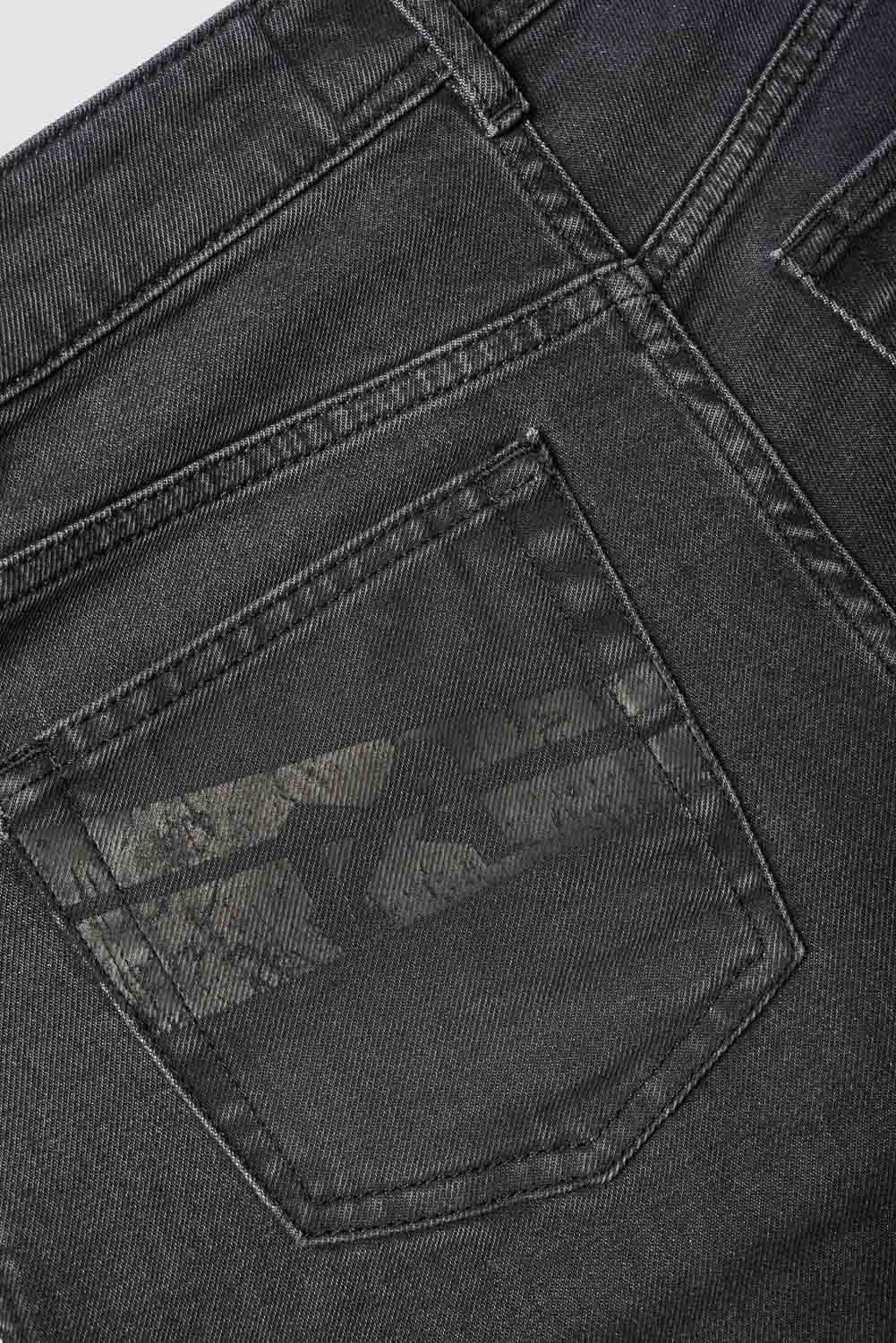 Close-up of a black denim pocket with stitching details