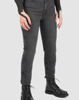 Person wearing black jeans and black boots on a white background