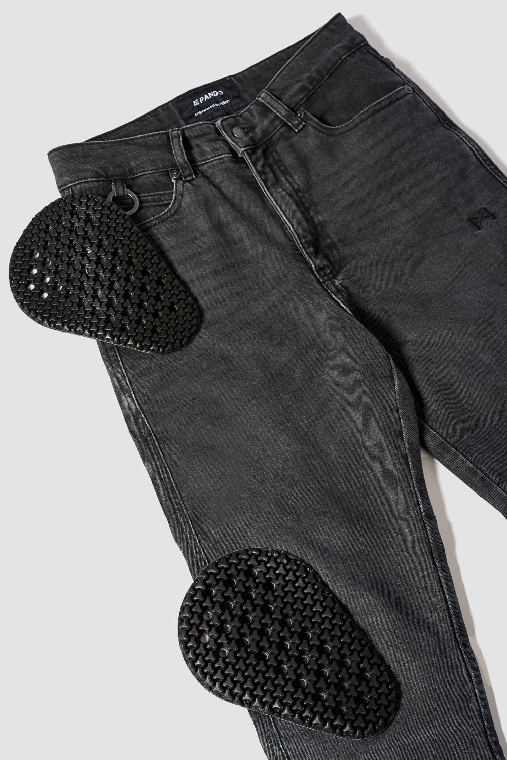 Black jeans with heart-shaped cutouts on a white background