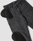 Black jeans with heart-shaped cutouts on a white background