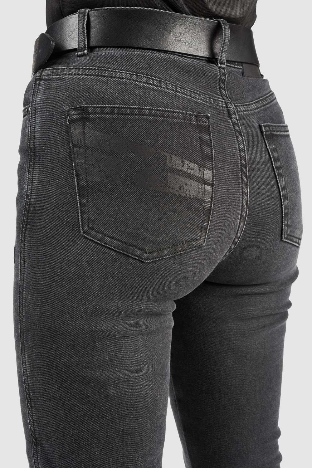 Black jeans with a visible brand logo on the back pocket against a white background
