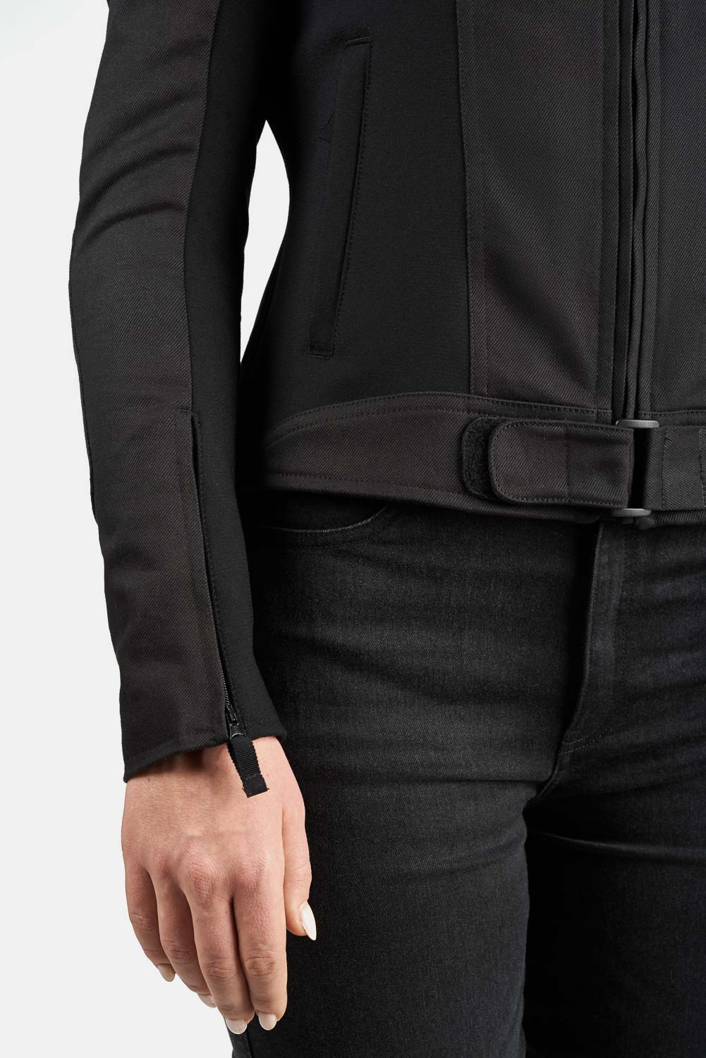 Person wearing a black jacket and pants on a white background