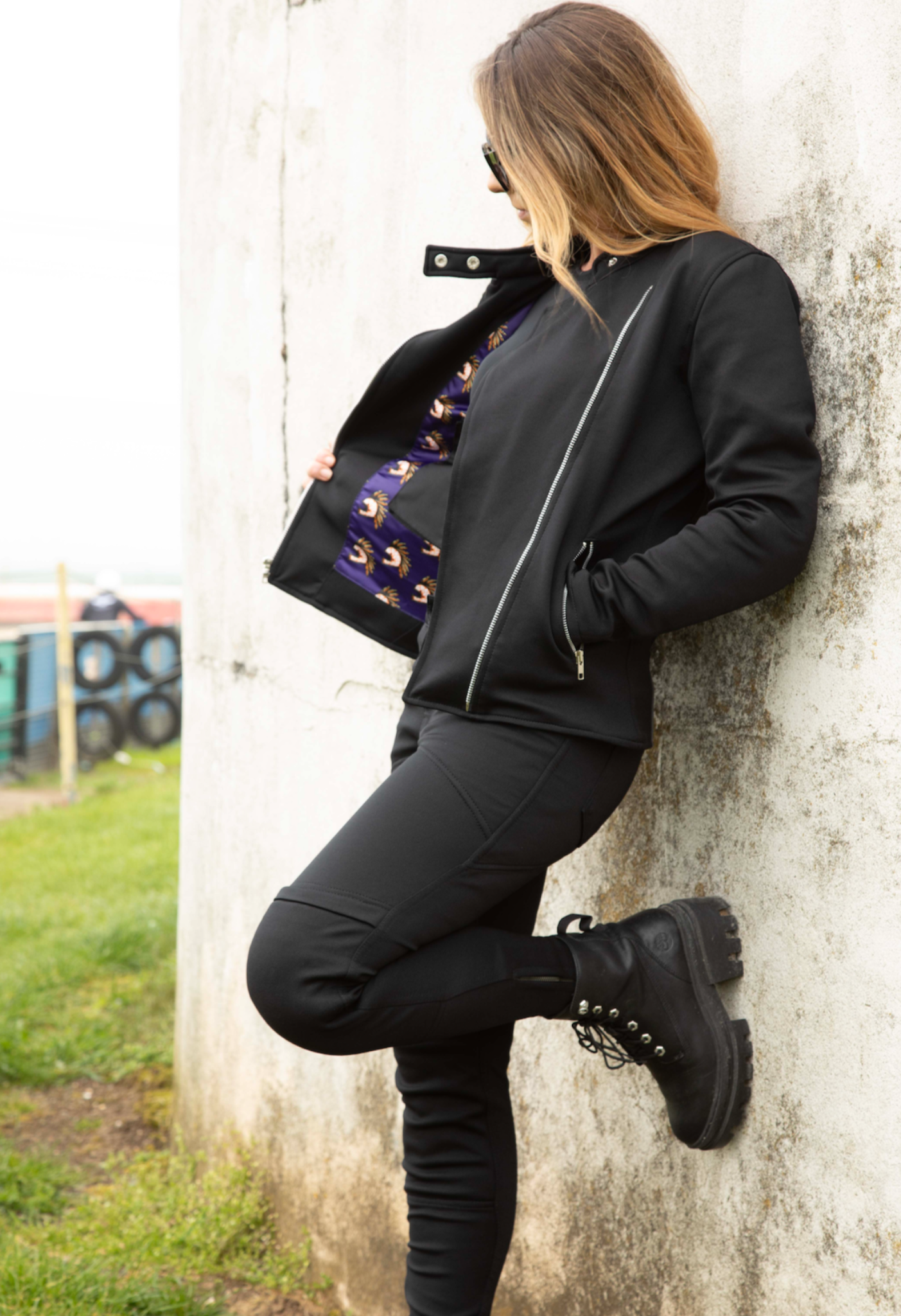 A woman wearing black mc jacket and black womens motorcycle pants with a front zip from Moto Girl 