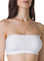 a close up photo of woman's breast wearing a white bandeau bra