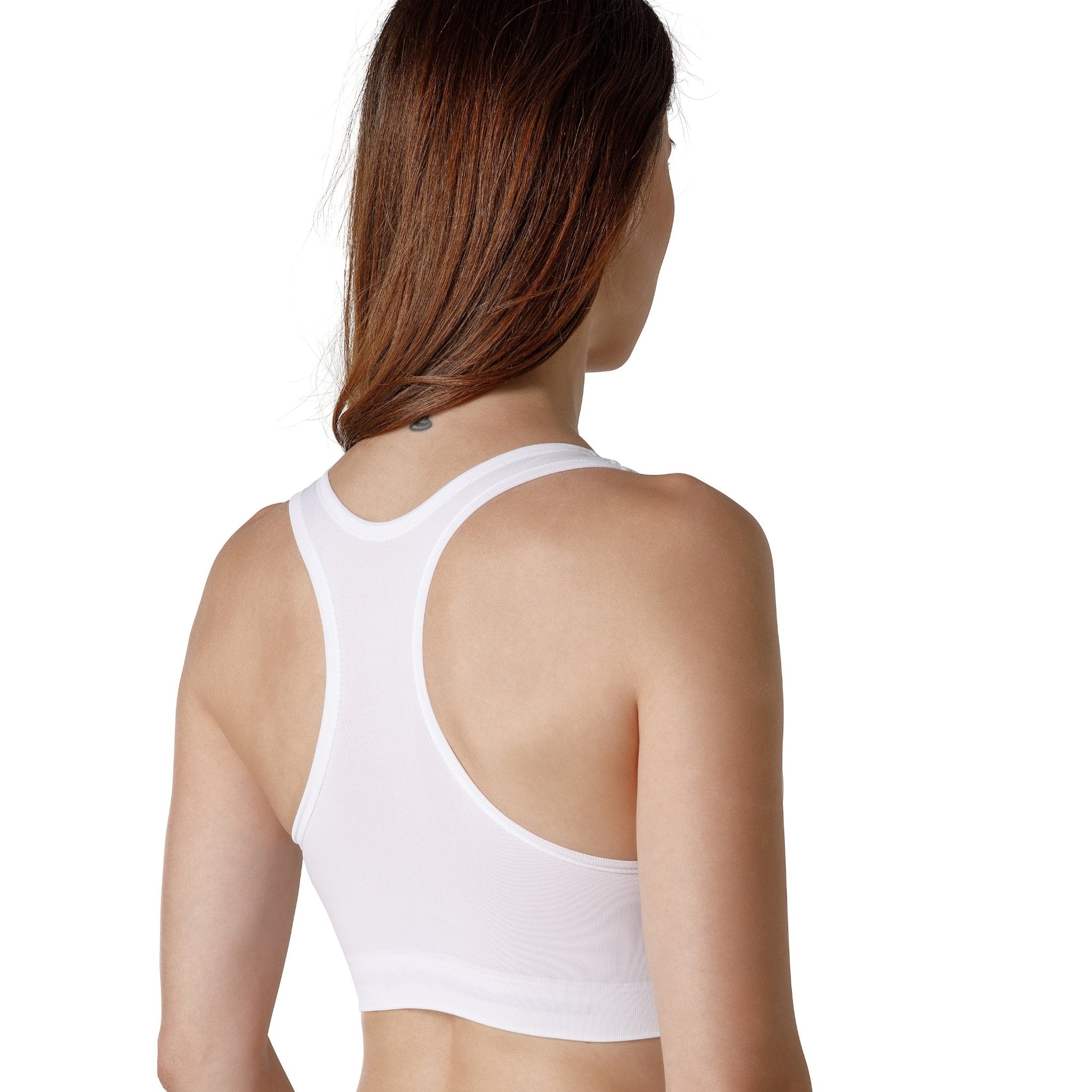 The back of a dark-haired woman wearing a white sport bra with wide straps from Tremonte. 