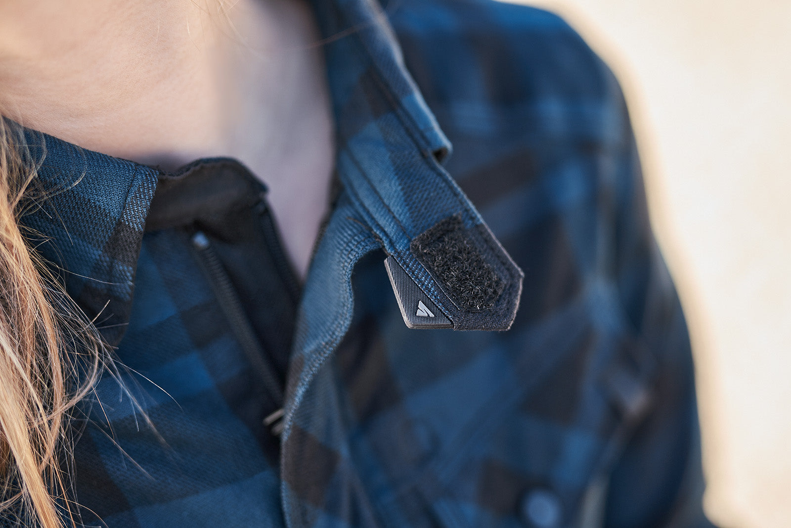 Close-up of a person wearing a blue camouflage jacket with a focus on the shoulder area.