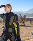 A young woman wearing shima motorcycle touring jacket for women in black/ fluo