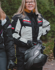 A woman wearing black white and red motorcycle textile jacket 